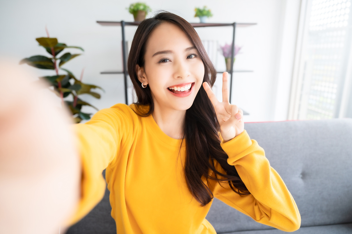 Female with Big Smile Sitting at Living Room